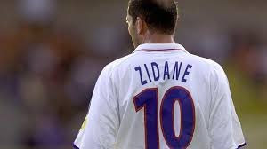 Zinedine Zidane striking the ball in a white Real Madrid jersey